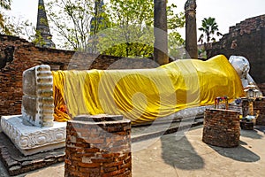 lying Buddha dressed in yellow scarf in temple Wat Yai Chai-mongkol