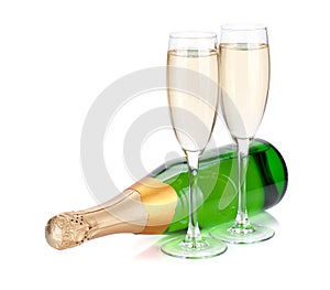 Lying champagne bottle and two glasses