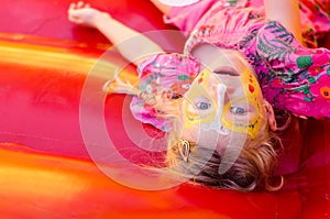 Lying child with facepainting