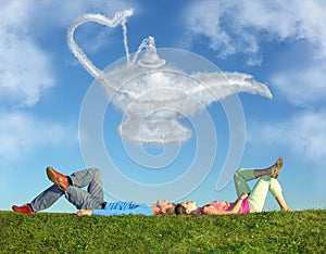 Lying couple on grass and dream alladin lamp cloud photo