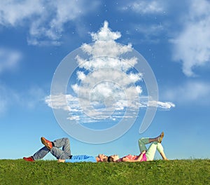Lying couple on grass and dream christmas tree