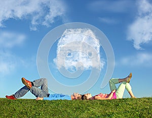 Lying couple on grass and dream house collage photo