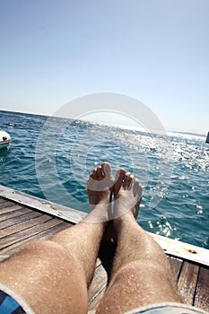 Lying on deck of yacht