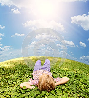 Lying on green grass carefree boy