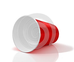 Lying horizontally red plastic cup.