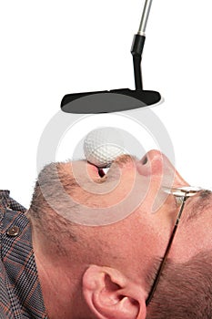 Lying man holds in mouth ball for golf of boss