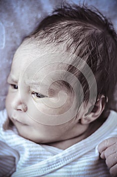 Lying, new born baby curled up sleeping on a blanket, multiple e