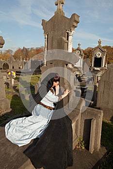 Lying on a tombstone