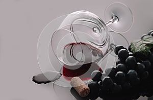 Lying vineglass with red grapevine