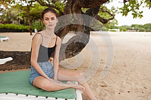 lying woman ocean beach smiling lifestyle sand attractive sea sunbed resort