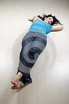 Lying woman on white laminate flooring