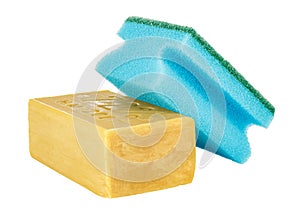 Lying yellow household soap with blue sponge for washing dishes on top isolated on white background