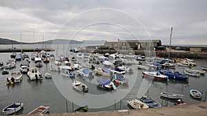Lyme Regis harbour Dorset England UK with boats moored