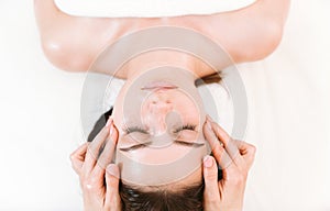 Lymphatic eye massage for reducing puffiness by professional massage therapist photo