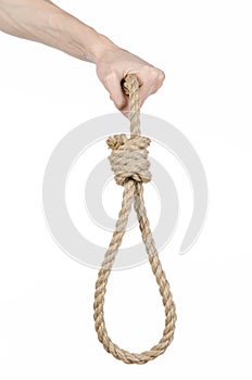 Lynching and suicide theme: man's hand holding a loop of rope for hanging on white isolated background