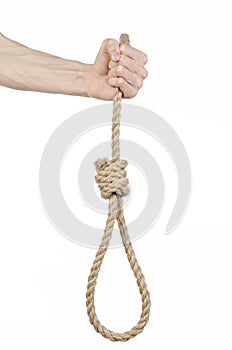 Lynching and suicide theme: man's hand holding a loop of rope for hanging on white isolated background