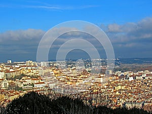 Lyon, France : Aerial view of the city wide panorama with landmarks surrounded by red rooftops and chimneys