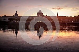 Hotel Dieu in Lyon, France, taken from the Rhone riverbank during an evening sunset.