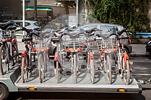 Velo`v bicycles on display on a truck, being ready to be lifted on a rental station.