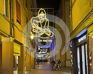 Lyrics from John Lennon's song Imagine in neon lights over Via d'Azeglio in Bologna, Italy.