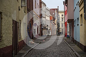 LÃÂ¼beck, Germany, September 11, 2021: Boetcherstrasse, a narrow alley near the harbor with cobblestones, historic houses, graffiti