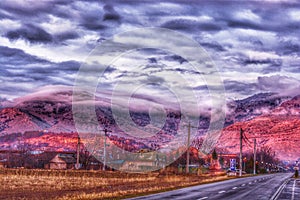 MÃÆcin mountain tops covered with clouds and lighted by red sunset