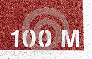 100 M painted white on a red track