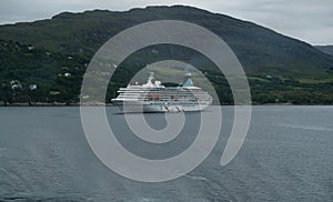 M V Artania with tugs getting ready to berth at Ullapool Scotland photo