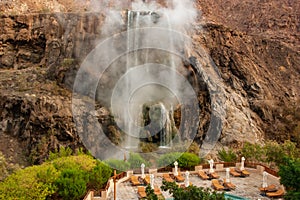 Ma\'in - hot springs. The oldest resort in Jordan. View from the spa hotel to mountain waterfalls with hot water and steam.