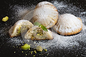 Maamoul - arabic homemade cookies filled with dates and pistachios. Close up