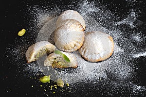 Maamoul - arabic homemade cookies filled with dates and pistachios. Close up.