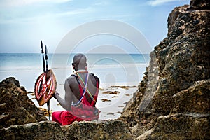 Maasai sitting by the ocean