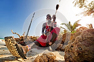 Maasai sitting by the ocean