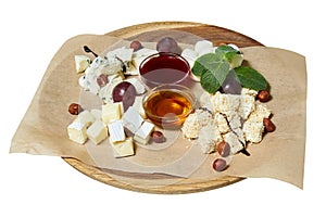 Maasdam, brie, camembert, roquefort cheeses on cheese board served with grapes