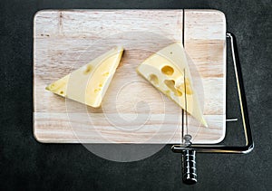 Maasdam cheese is cut on a special Board