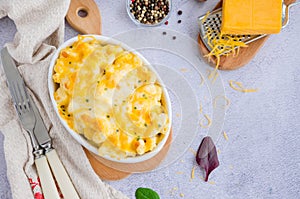 Mac and cheese. Traditional baked macaroni with cheese in baking form. American cuisine. Horizontal orientation. Top view. photo