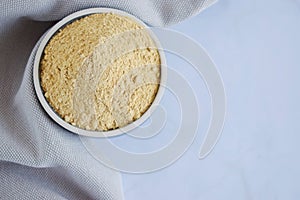 Maca powder in a bowl, super food. Flat lay, copy space