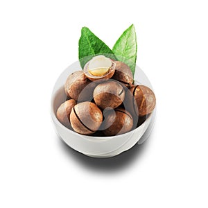 Macadamia nut in a white bowl against a white isolated background