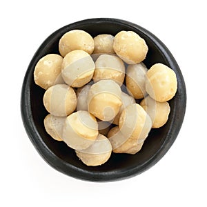 Macadamia Nuts in Black Bowl Overhead View Isolated photo