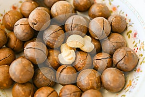 Macadamia nuts on bowl, fresh natural shelled raw macadamia nuts, close up pile of roasted macadamia nut