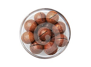 Macadamia nuts in bowl on a white