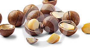 Macadamia nuts with broken nut shell isolated on white background