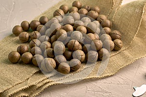 a macadamia nuts on burlap background backdrop