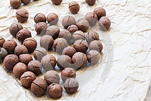 Macadamia nuts on a craft paper background.