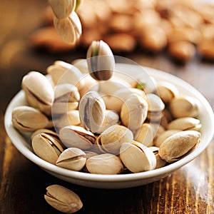 Macadamia nuts falling into bowl