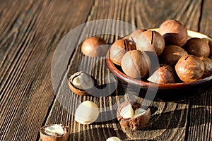 Macadamia nuts on a wooden background.