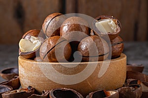 Macadamia nuts in wooden cup on table