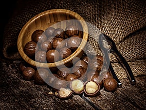 Macadamia nuts on wooden table.