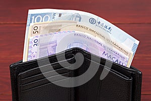 Macanese money in the black wallet