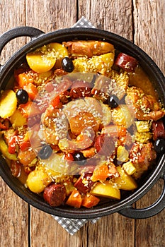 Macanese Style Portuguese Chicken Galinha a Portuguesa Po Kok Gai close up in the pan. Vertical top view photo